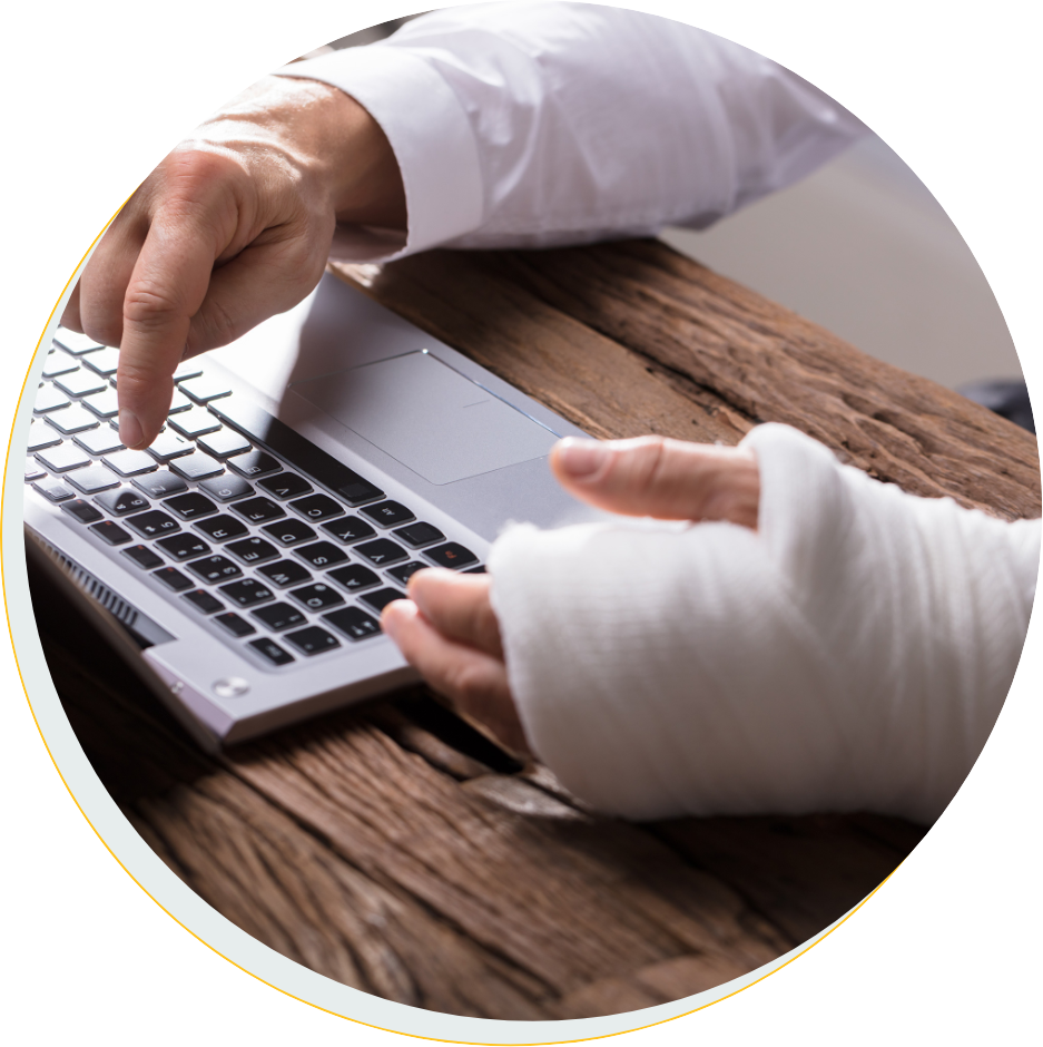 Businessperson with hand injury using laptop