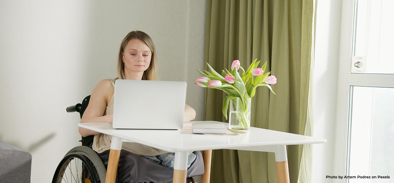 Woman with disability using her laptop 